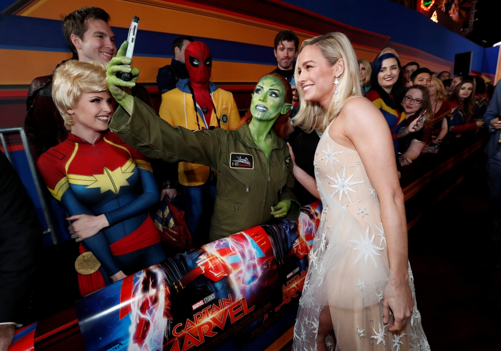 Cast member Brie Larson takes photos with fans at the premiere for the movie 