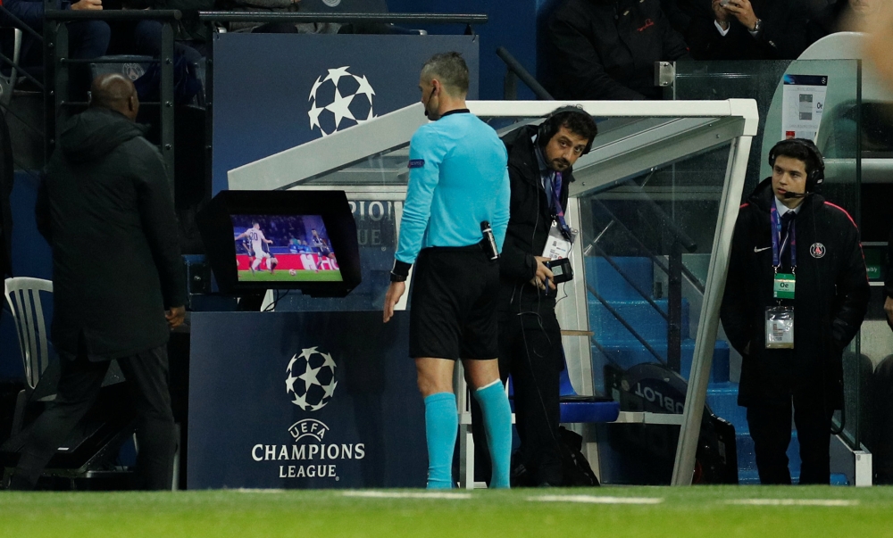 Referee Damir Skomina reviews an incident on VAR before awarding a penalty to Manchester United. Reuters/John Sibley