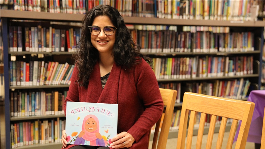 Hena Khan poses for a photo with her new children's book 