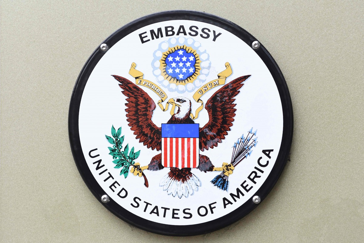 Signs attached to the railings of the US embassy in Grosvenor square in central London on January 12, 2018. AFP/Daniel Sorabji