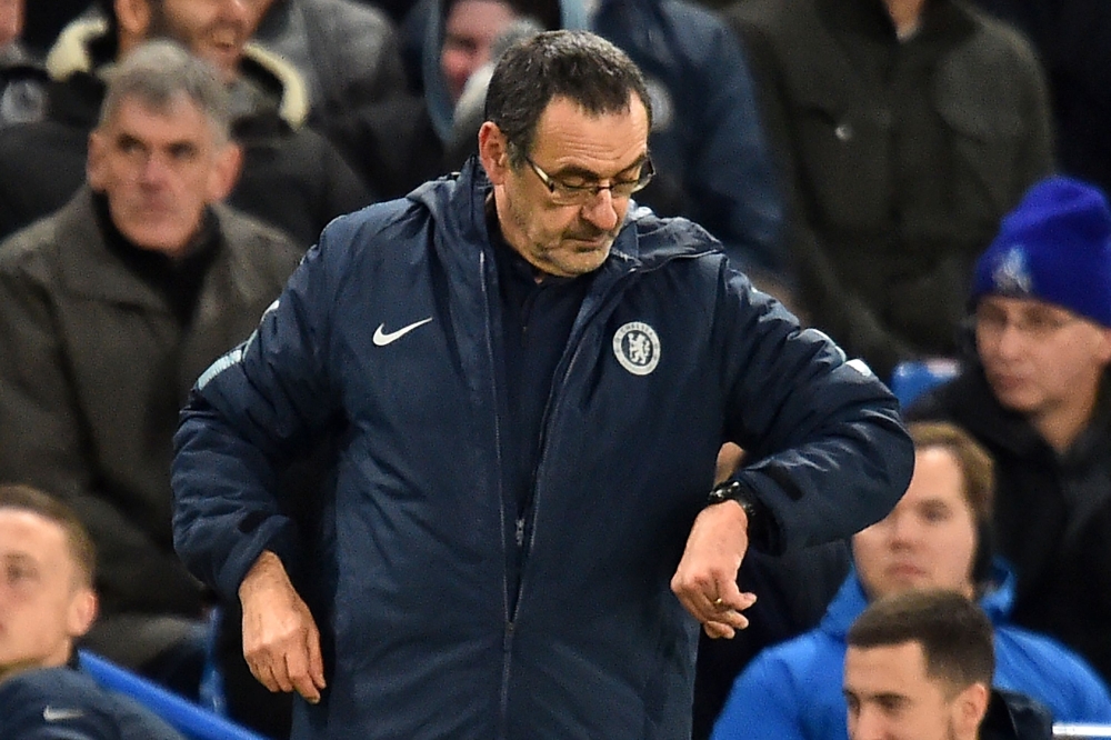 Chelsea's Italian head coach Maurizio Sarri checks his watch during the first leg of the UEFA Europa League round of 16 football match between Chelsea and Dynamo Kiev at Stamford Bridge stadium in London on March 7, 2019. / AFP / Glyn KIRK