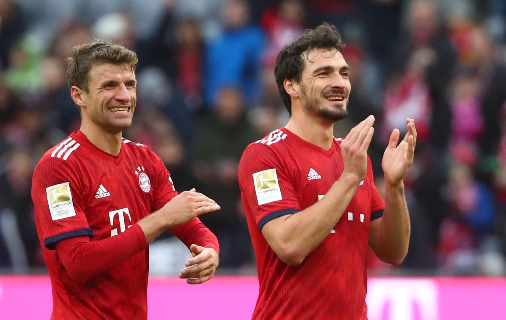 Bayern Munich's Thomas Mueller and Mats Hummels applaud the fans after the match REUTERS/Michael Dalder