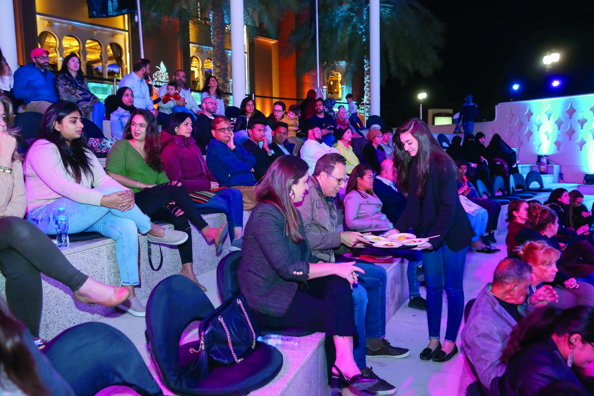 The guests enjoying the live cooking show.