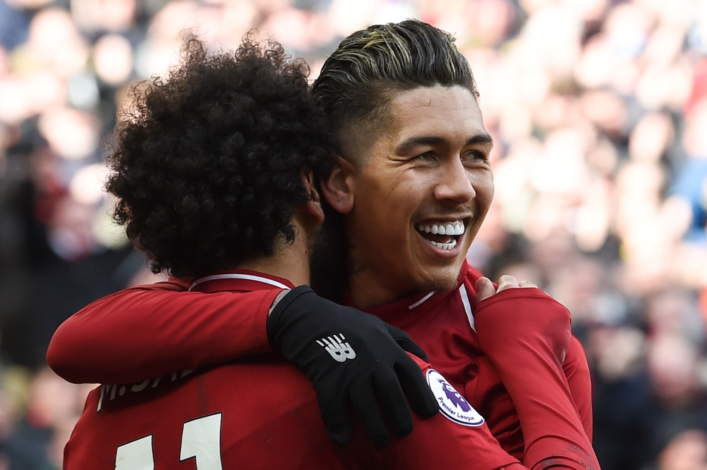 Liverpool's Brazilian midfielder Roberto Firmino (C) celebrates scoring their third goal during the English Premier League football match between Liverpool and Burnley at Anfield in Liverpool, north west England on March 10, 2019.  AFP / Paul ELLIS 