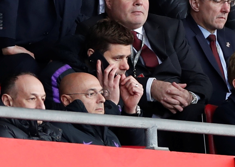 Tottenham manager Mauricio Pochettino on a phone in the stands as chairman Daniel Levy looks. Reuters/Paul Childs 