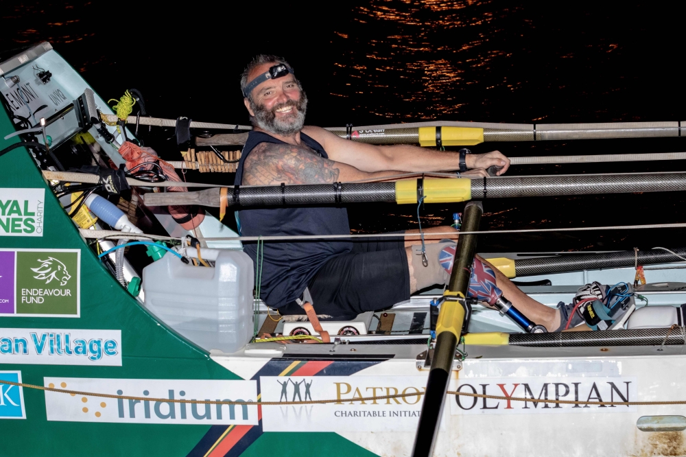 Lee Spencer, a 49-year-old former British marine, known as 'The Rowing Marine', row as he arrives in Cayenne, French Guiana, early on March 11, 2019, after smashing solo Atlantic rowing record from mainland Europe to South America. AFP / Jody Amiet