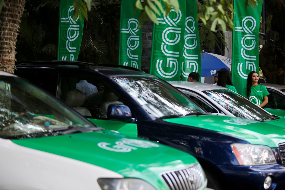 Grab cars are seen during a launch ceremony in Phnom Penh, Cambodia, December 19, 2017. Reuters/Samrang Pring