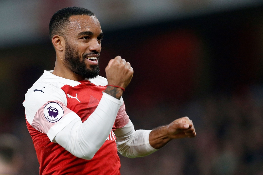 FILE PHOTO:  In this file photo taken on February 27, 2019 Arsenal's French striker Alexandre Lacazette celebrates scoring his team's fifth goal during the English Premier League football match between Arsenal and Bournemouth at the Emirates Stadium in Lo