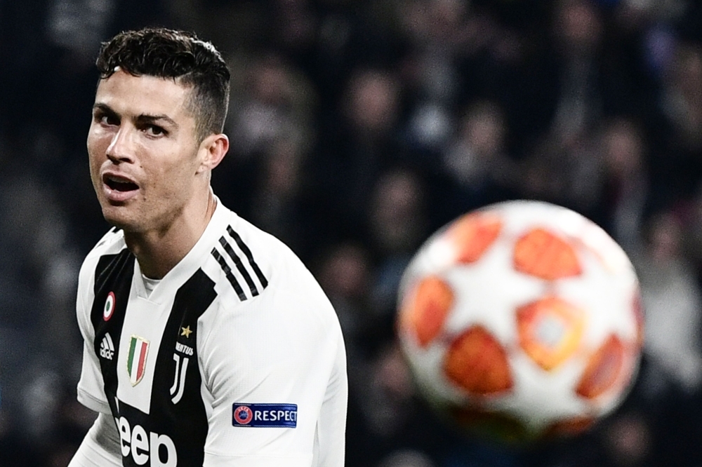Juventus' Portuguese forward Cristiano Ronaldo eyes the ball during the UEFA Champions League round of 16 second-leg football match Juventus vs Atletico Madrid on March 12, 2019 at the Juventus stadium in Turin. AFP / Marco Bertorello 