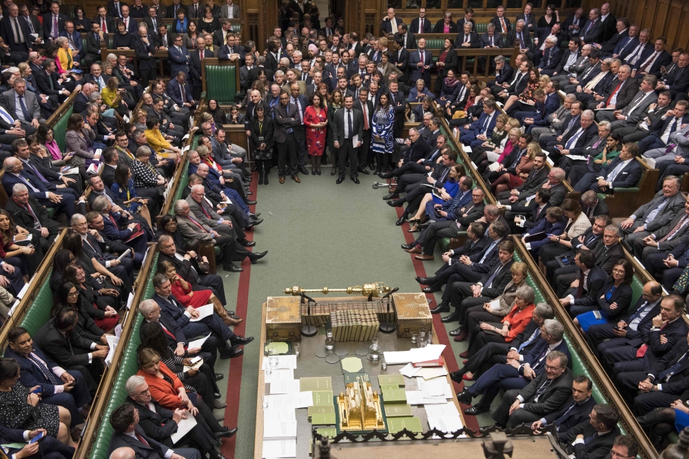 A handout photograph released by the UK Parliament shows packed chamber awaits the tellers for the result of the meaningful vote on the government's Brexit deal in the House of Commons in London on March 12, 2019. AFP PHOTO / MARK DUFFY / UK Parliament