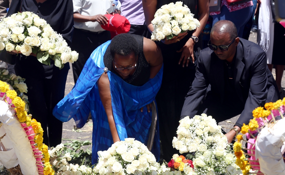 Relatives of Ethiopia Airlines victims, who lost their lives in the crash, place flowers at the crash site of Ethiopian Airlines Flight 302 in Addis Ababa, Ethiopia on March 16, 2019. Minasse Wondimu Hailu - Anadolu 