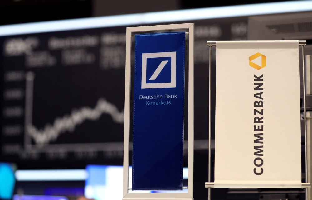 FILE PHOTO: Banners of Deutsche Bank and Commerzbank are pictured in front of the German share price index, DAX board, at the stock exchange in Frankfurt, Germany, September 30, 2016. REUTERS/Kai Pfaffenbach