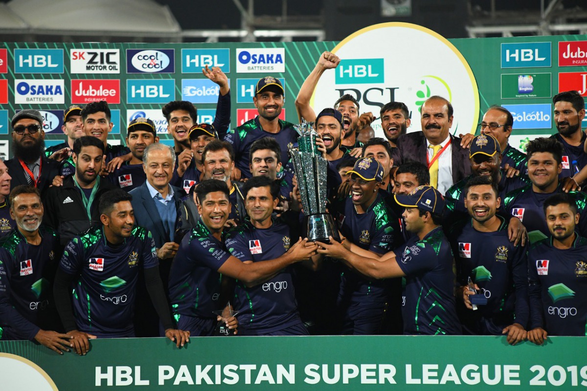 Quetta Gladiators players and officials celebrate with the   HBL Pakistan Super League trophy after defeating Peshawar Zalmi by eight wickets at the National Stadium in Karachi yesterday.