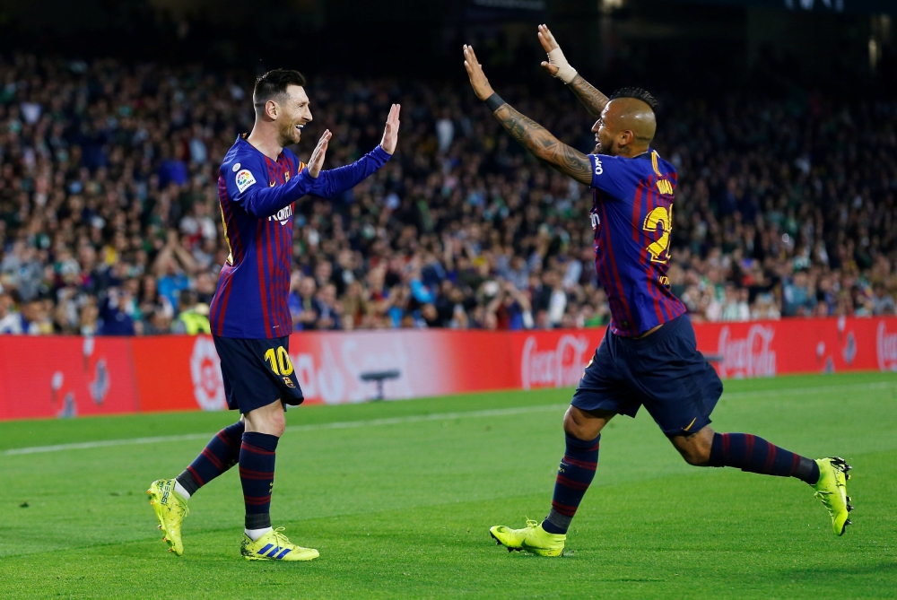 Barcelona's Lionel Messi celebrates scoring their first goal with Arturo Vidal REUTERS/Marcelo del Pozo