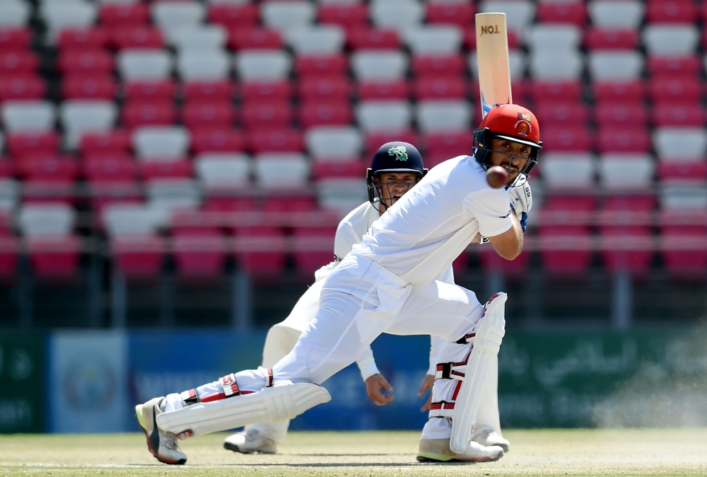 Afghanistan's Rahmat Shah plays a shot during day four of the Test cricket match between Afghanistan and Ireland at the Rajiv Gandhi International Cricket Stadium in the northern Indian city of Dehradun on March 18, 2019. AFP / Money Sharma 