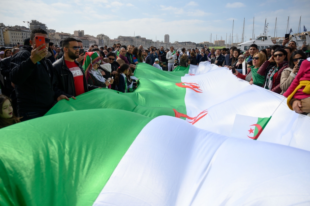 Demonstrators wave an Algerian flag during a protest over fears of plot to prolong the Algerian president's rule, on March 17, 2019, in Marseille, southeastern France. AFP / Christophe SIMON