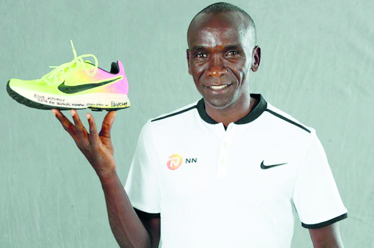 Eliud Kipchoge with his shoe which he wore during his gold medal winning run at the Rio Olympics. Picture courtesy: Giancarlo Colombo/IAAF