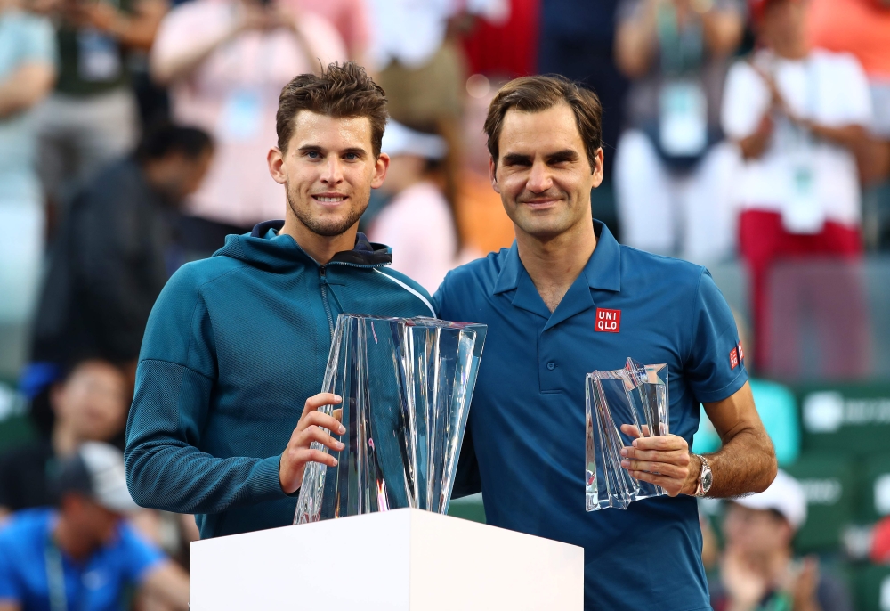 Dominic Thiem of Austria holds the championship trophy after his men's singles final victory against Roger Federer of Switzerland on day fourteen of the BNP Paribas Open at the Indian Wells Tennis Garden on March 17, 2019 in Indian Wells, California. Cliv