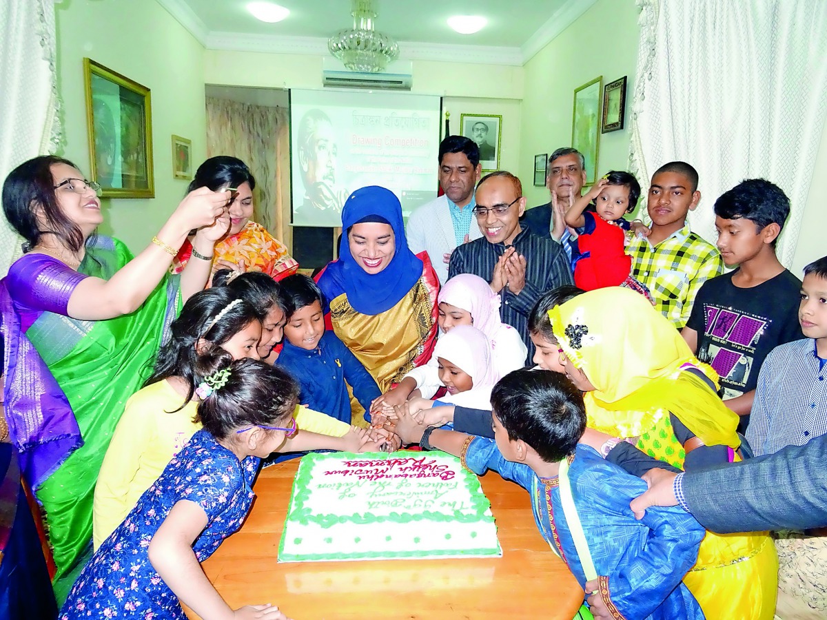 The Ambassador of Bangladesh to the State of Qatar, Ashud Ahmed, along with children cutting a cake to celebrate the 99th birth anniversary of Bangabandhu Sheikh Mujibur Rahman.