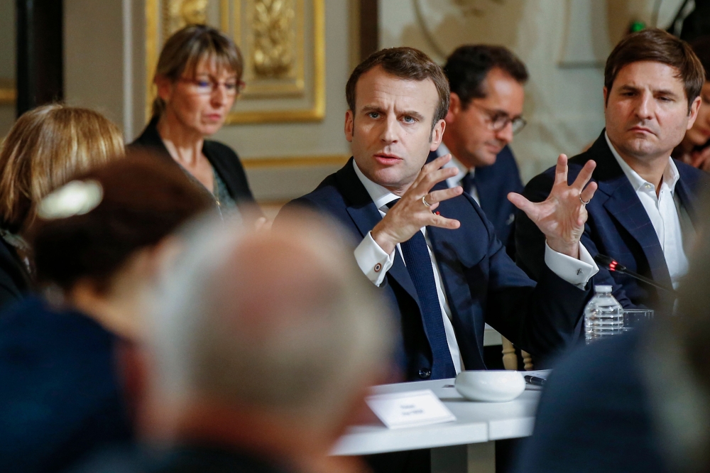 French President Emmanuel Macron gestures during a meeting with some 60 intellectuals as part of the 
