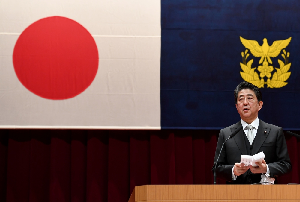 Japanese Prime Minister Shinzo Abe delivers his speech while attending the graduation ceremony of the Defense Academy in Yokosuka, Kanagawa prefecture on March 17, 2019. AFP / Toshifumi Kitamura