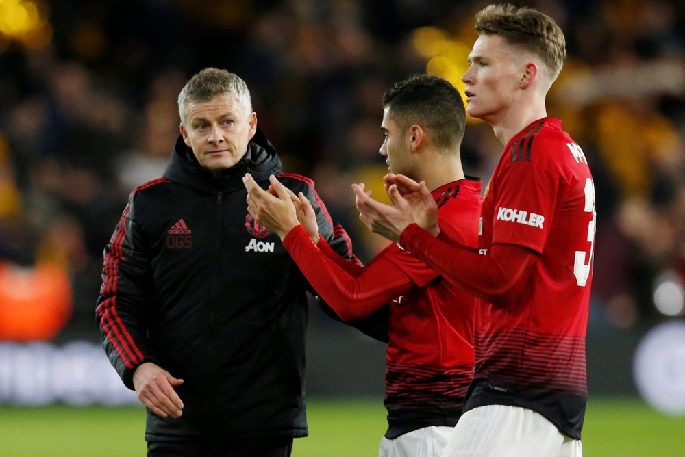 Manchester United interim manager Ole Gunnar Solskjaer looks dejected after the match with Scott McTominay and Andreas Pereira REUTERS/Andrew Yates
