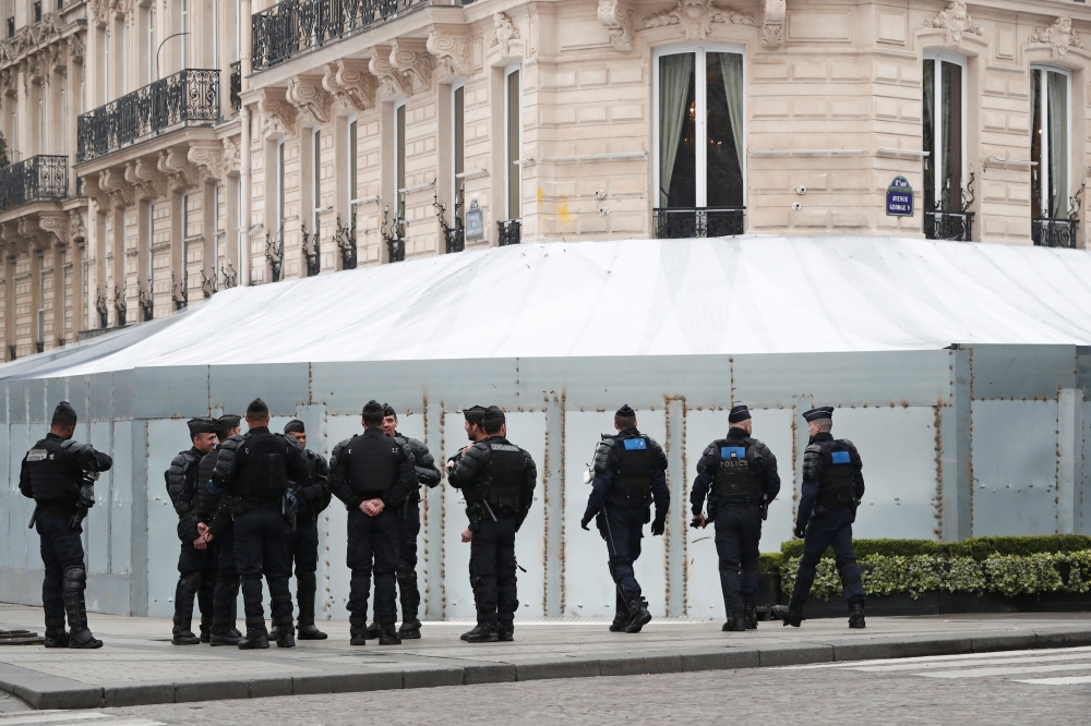 French gendarmes and riot police officers secure the Champs-Elysees avenue in front of the famed restaurant Fouquet's during the Act XIX (the 19th consecutive national protest on a Saturday) of the 