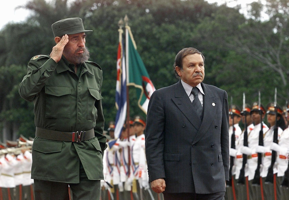 A file photo taken on April 15, 2000 shows Cuban president Fidel Castro (L) and Abdelaziz Bouteflika (R), president of Algeria, saluting troops in a ceremony in Havana. AFP / Adalberto Roque
 