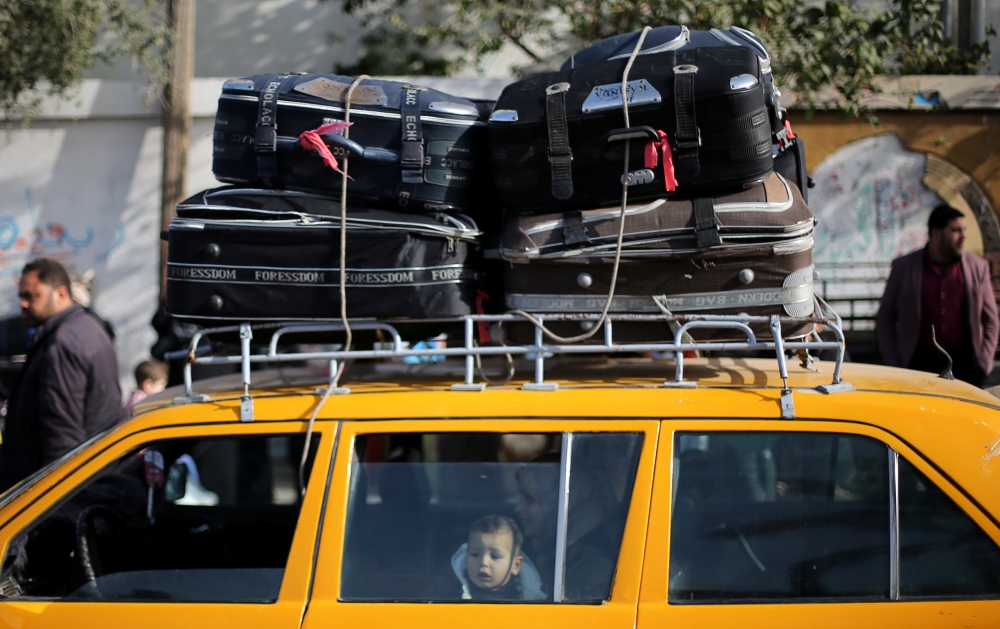 A Palestinian boy waits to cross the Rafah border after it was opened by Egyptian authorities for humanitarian cases in the southern Gaza Strip on February 09, 2018. Reuters/Ibraheem Abu Mustafa