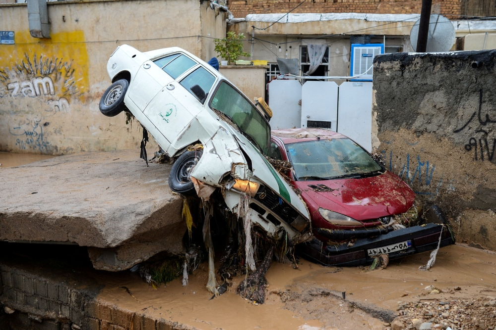 FILE PHOTO: Damaged vehicles are seen after a flash flooding in Shiraz, Iran, March 26, 2019. 