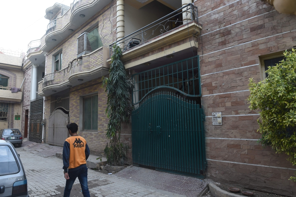 In this picture taken on March 13, 2019, a Pakistani boy walks past the house where 16-year-old Uzma worked as a maid, in Lahore, before being killed and dumped in a city canal. AFP / Arif Ali