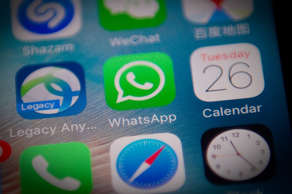 This file photo illustration taken on September 26, 2017 shows the Whatsapp application logo (C) on a smartphone screen in Beijing. AFP /Nicolas Asfouri 