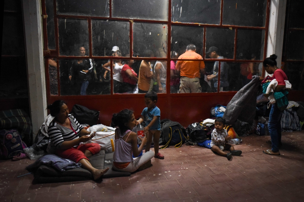 Central American migrants -taking part in a caravan called Migrant Viacrucis rest at a sports center field in Matias Romero, Oaxaca state Mexico on April 2. 2018. AFP/Victoria Razo