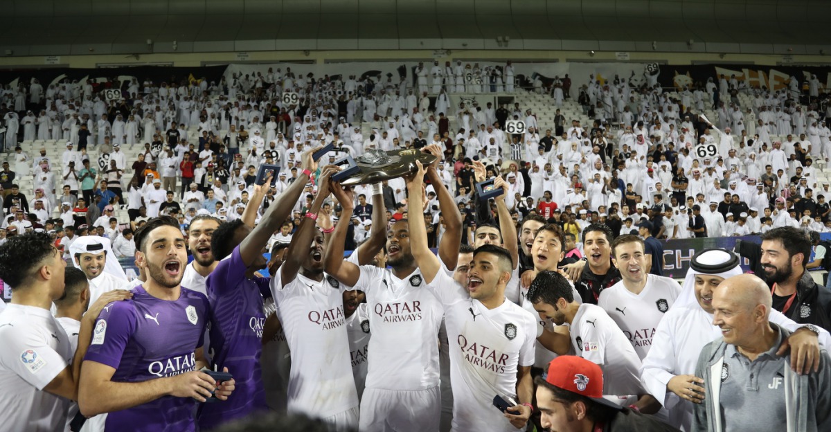 Al Sadd players and officials celebrate after winning the QNB Stars League title in Doha on Thursday.