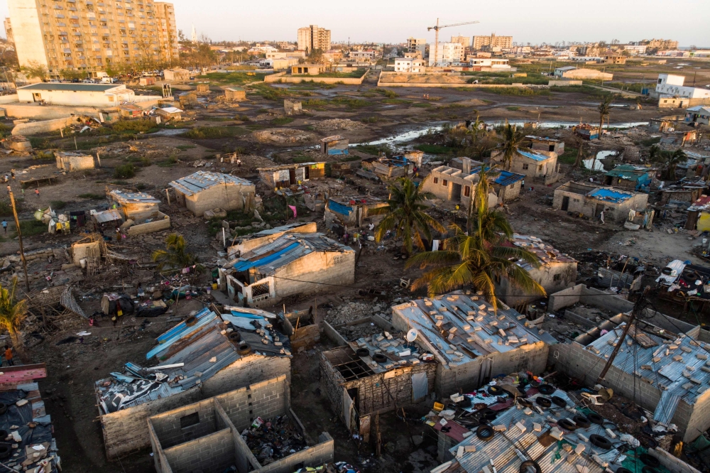 Debris and destroyed buildings which stood in the path of Cyclone Idai can be seen in this aerial photograph over the Praia Nova neighbourhood in Beira on April 1, 2019.   AFP / Guillem Sartorio
