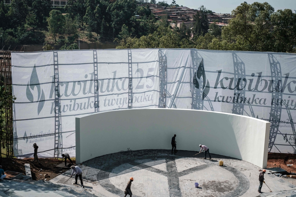 Workers clean the stage at the Genocide Memorial in Kigali, ahead of the 25th commemoration of the 1994 Genocide against the Tutsi on April 6, 2019. / AFP / Yasuyoshi CHIBA