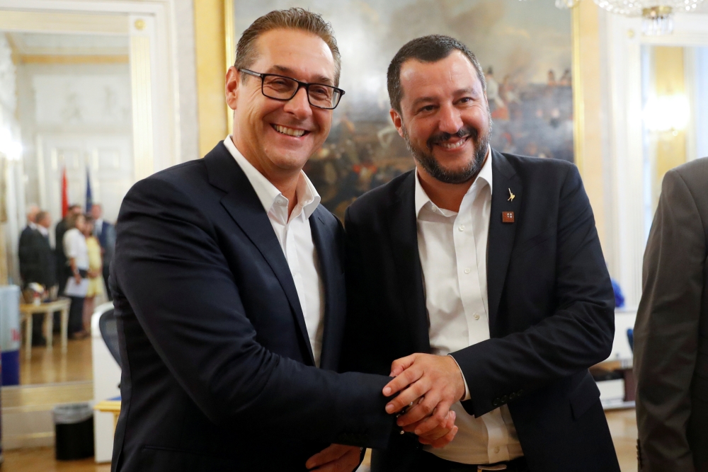 FILE PHOTO: Italian Deputy Prime Minister Matteo Salvini and Austrian Vice-Chancellor Heinz-Christian Strache shake hands before a joint news conference in Vienna, Austria, September 14, 2018. REUTERS/Leonhard Foeger/File Photo