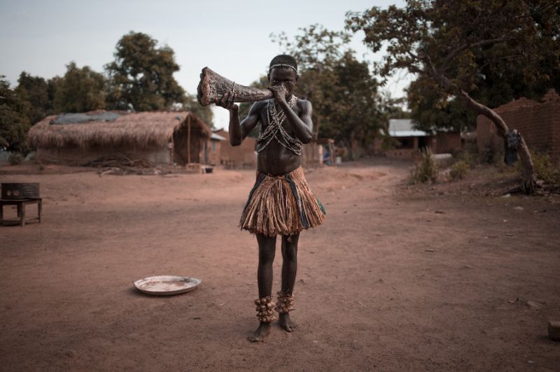 A Broto musician blows into the side of his wooden instrument to produce a deep, resonant sound from the bell.  AFP / Florent Vergnes