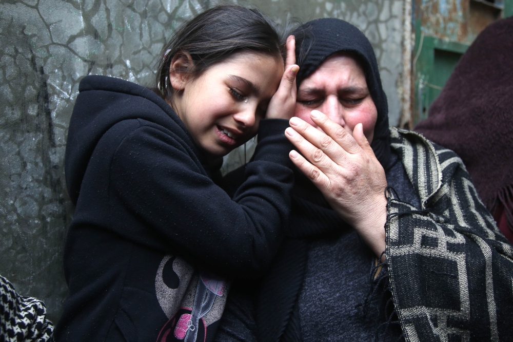 Relatives of Palestinian Ali Adwan, who was killed during a clash with Israeli forces in Qalandia refugee camp, mourn during his funeral near Ramallah, West Bank on April 2, 2019. (Issam Rimawi - Anadolu Agency)