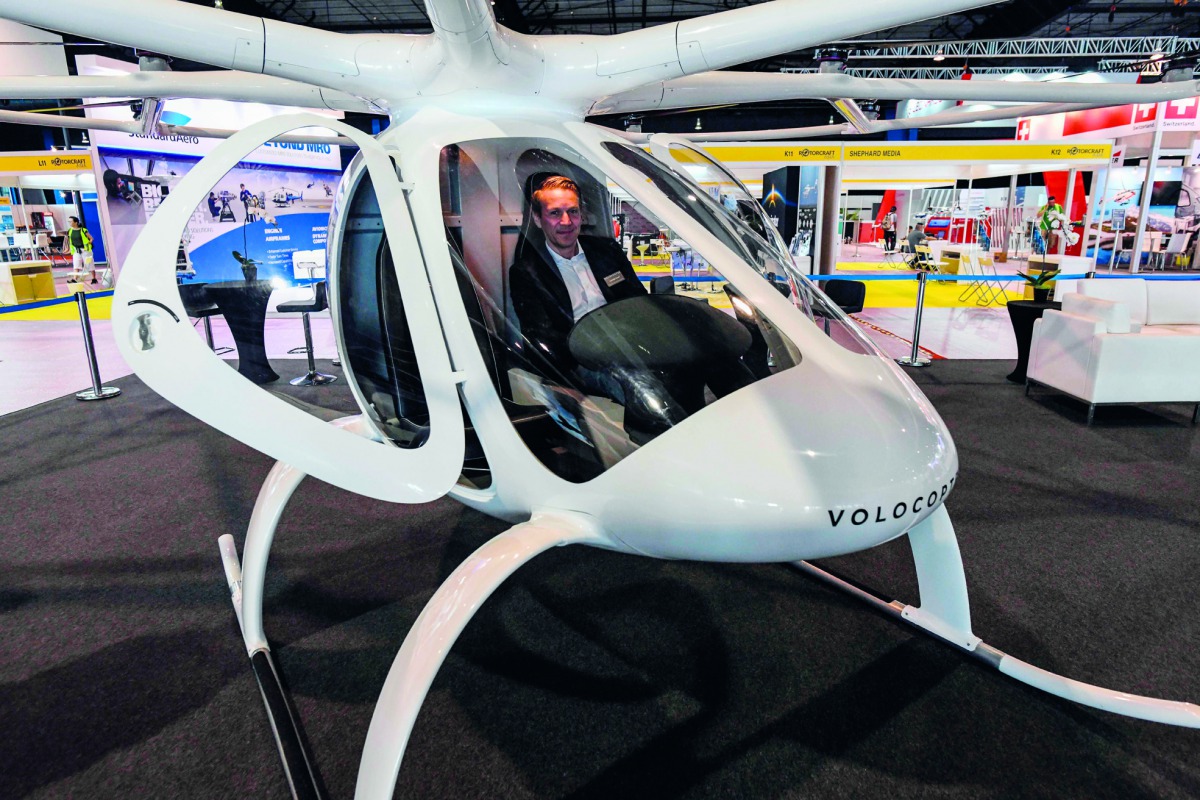 hristian Bauer, Volocopter's head of business development, poses sitting in a passenger drone Volocopter 2X during a media preview at Rotorcraft and Unmanned Systems exhibition in Singapore on April 8, 2019. / AFP / Roslan Rahman
