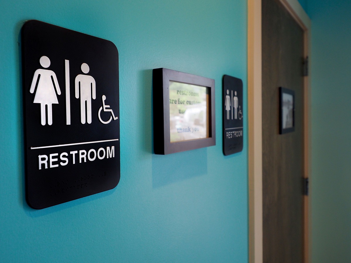 Unisex signs hanging outside bathrooms at Toast Paninoteca in Durham North Carolina, May 9, 2016.  AFP/Getty Images North America/Sara D Davis