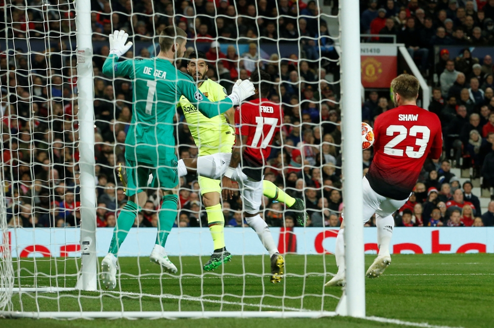 A header by Barcelona’s Luis Suarez (second left), deflects off Manchester United’s Luke Shaw (right), into their own goal during the Champions League Quarter Final First Leg match played at the Old Trafford in Manchester, Britain, on Wednesday.