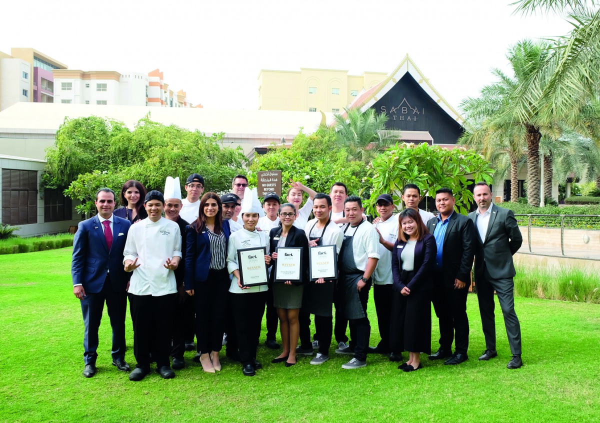Officials and employees of The Westin Doha Hotel and Spa posing for a group picture with the awards.