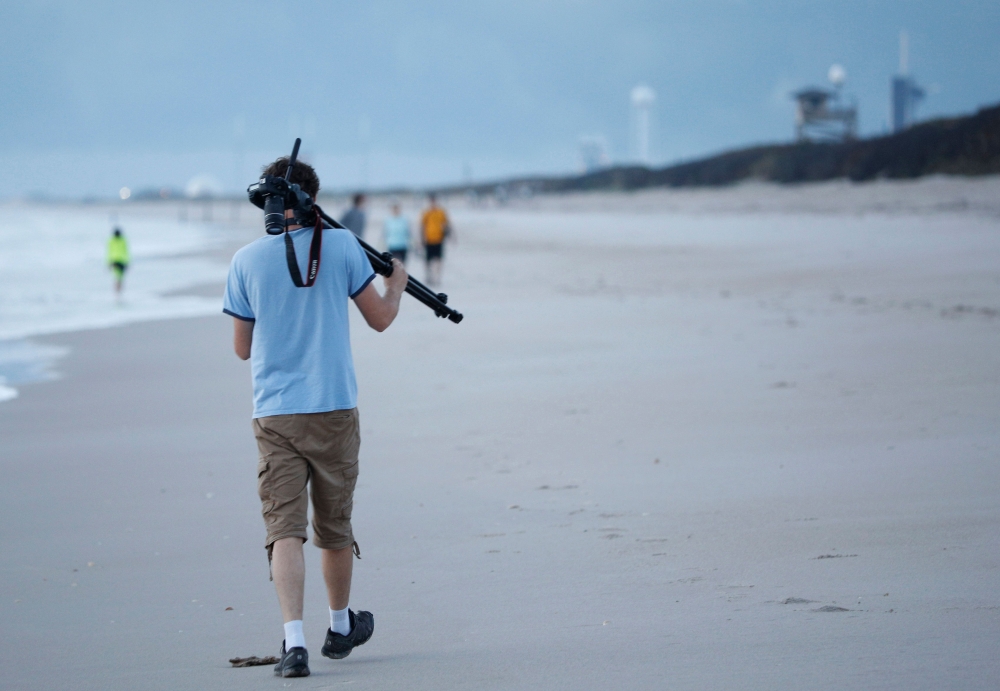 A visitor arrives at sunrise at Playalinda Beach, just north of the Kennedy Space Center in Florida, to find a good vantage point on April 10, 2019.  AFP / Gregg Newton 
