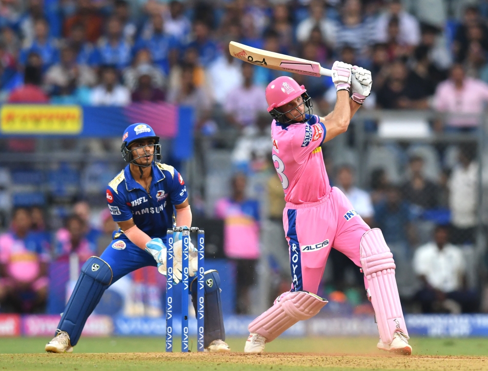 Rajasthan Royals batsman Jos Buttler (R) plays a shot during the 2019 Indian Premier League (IPL) Twenty20 cricket match between Mumbai Indians and Rajasthan Royals at the Wankhede Stadium in Mumbai on April 13, 2019. (AFP / PUNIT PARANJPE)