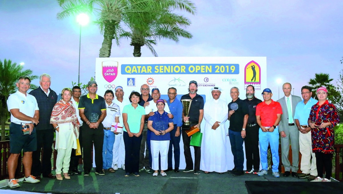 The podium winners at the Qatar Senior Open golf tournament pose for a picture with officials of Qatar Golf Association at Doha Golf Club. 
