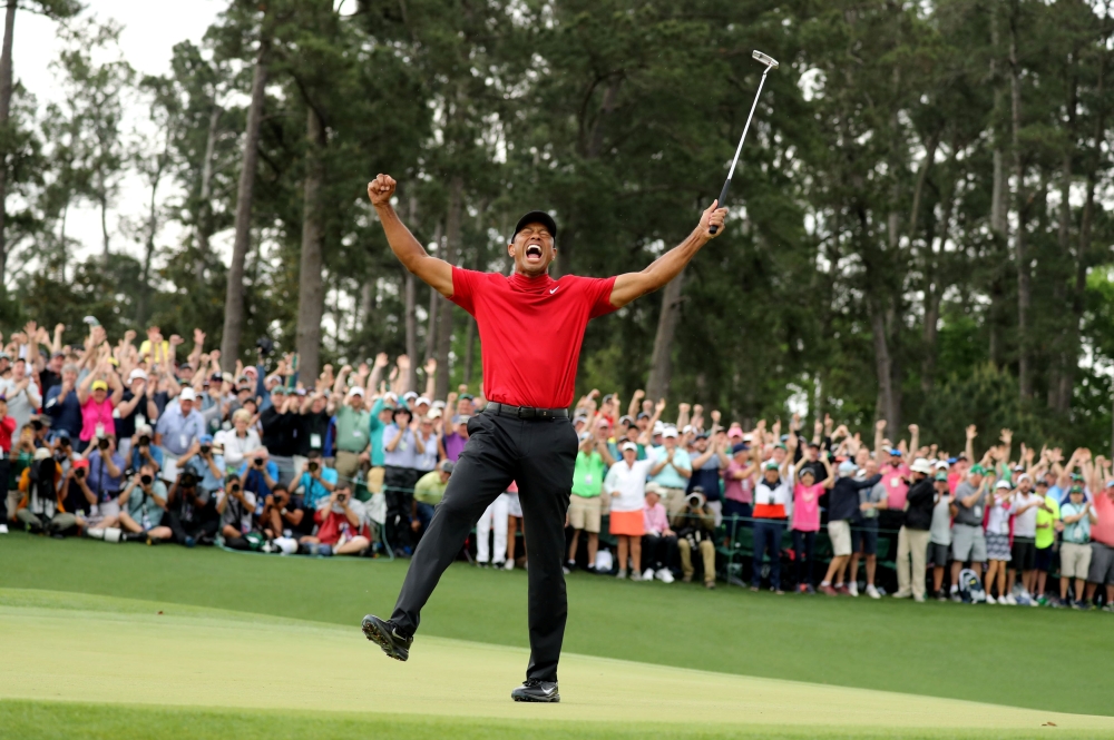 Tiger Woods of the U.S. celebrates on the 18th hole after winning the 2019 Masters, April 14, 2019. REUTERS/Lucy Nicholson