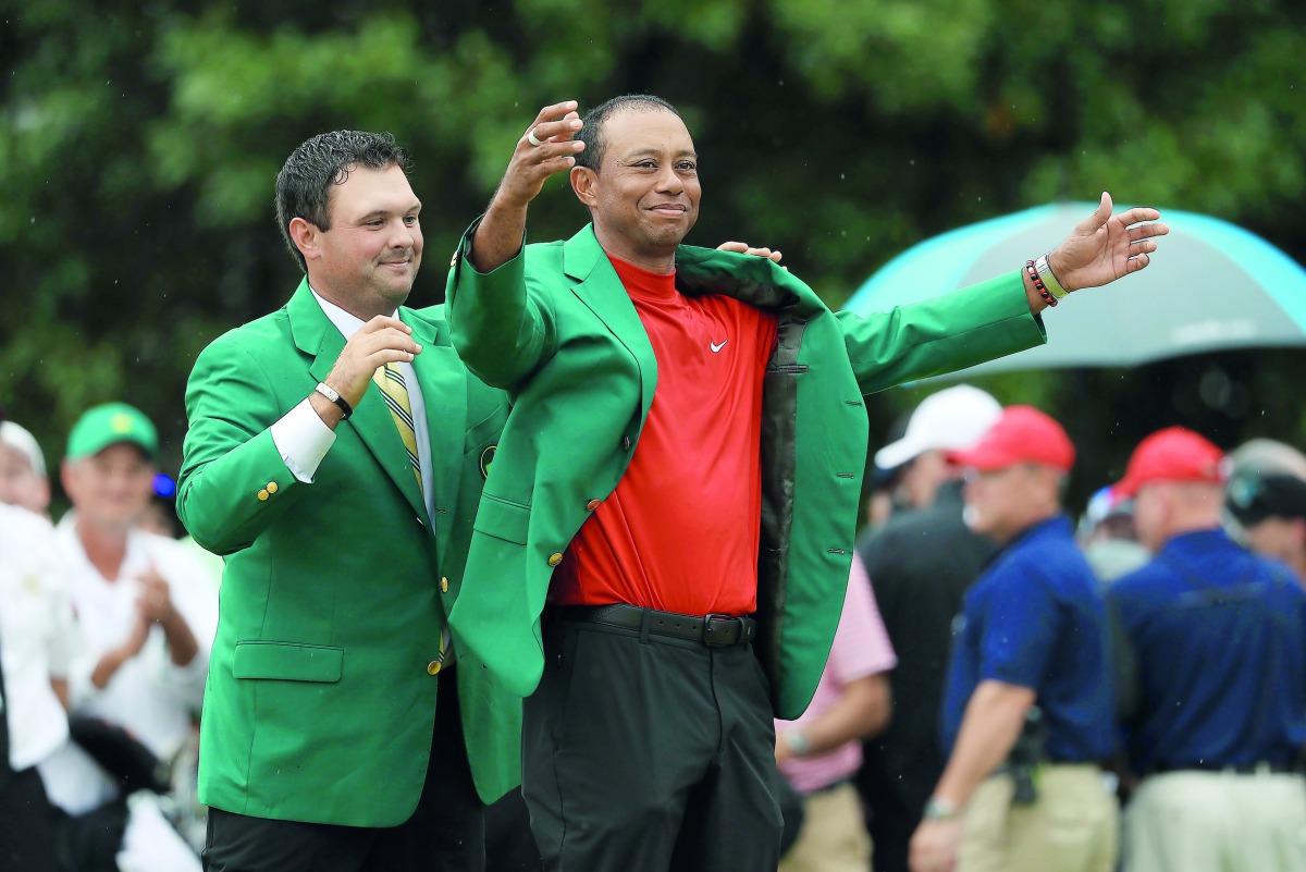 Tiger Woods (R) of the United States is awarded the Green Jacket by Masters champion Patrick Reed (L) during the Green Jacket Ceremony after winning the Masters at Augusta National Golf Club on April 14, 2019 in Augusta, Georgia. Mike Ehrmann/Getty Images