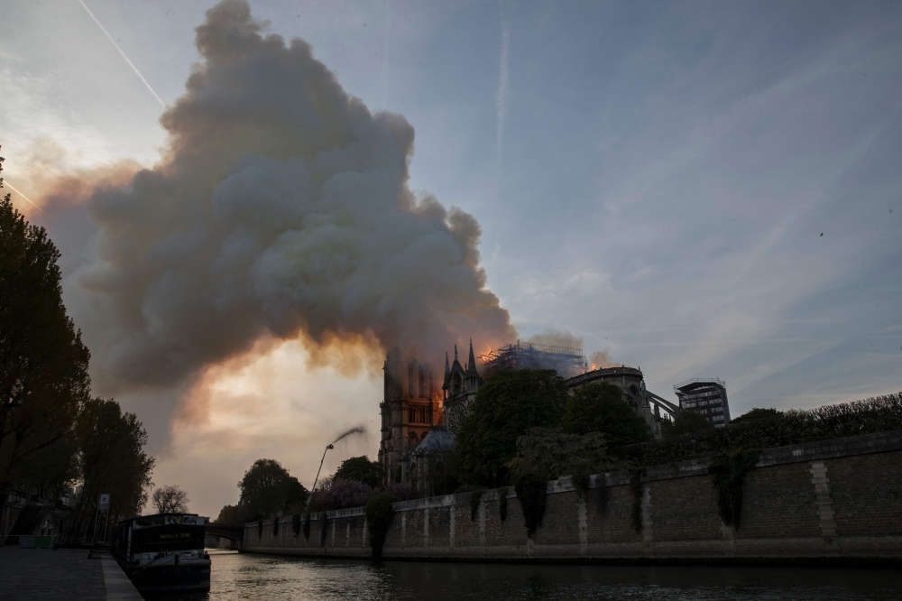 Smoke and flames billow from the roof at Notre-Dame Cathedral in Paris on April 15, 2019. AFP / Thomas Samson