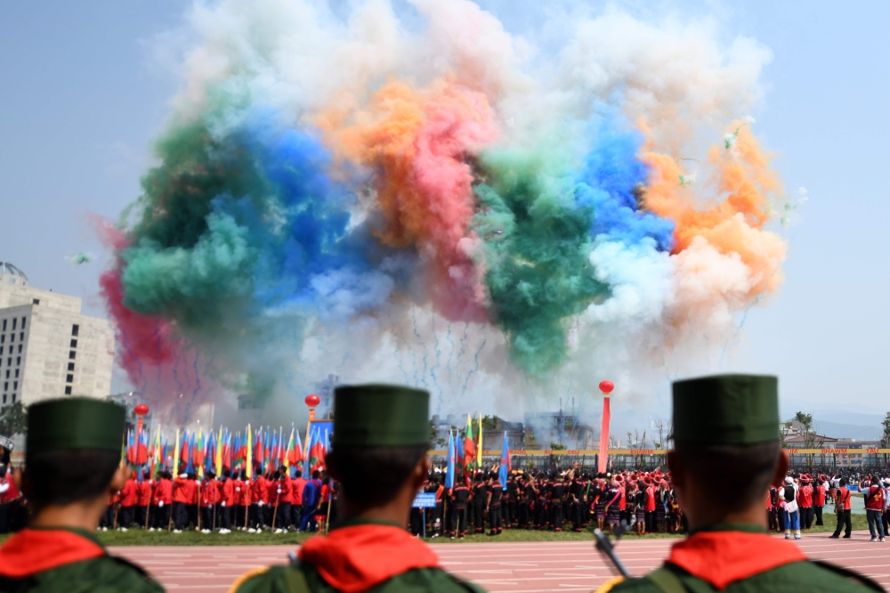 Day fireworks go off during a military parade, to commemorate 30 years of a ceasefire signed with the Myanmar military in the Wa State, in Panghsang on April 17, 2019. AFP / Ye Aung Thu
 